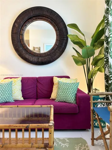 a living room with a couch and a potted plant