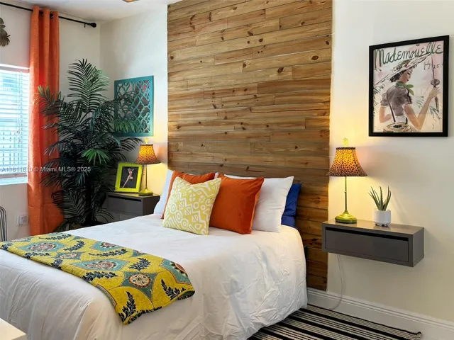 a bedroom with a bed and a potted plant