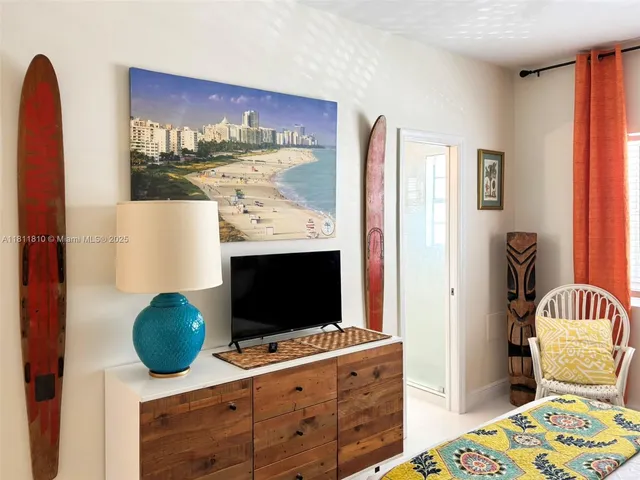 a bedroom with a bed and a television