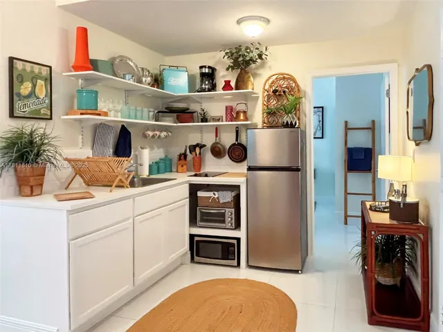 a kitchen with stainless steel appliances granite countertop a refrigerator and a stove