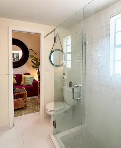 a bathroom with a toilet and a shower