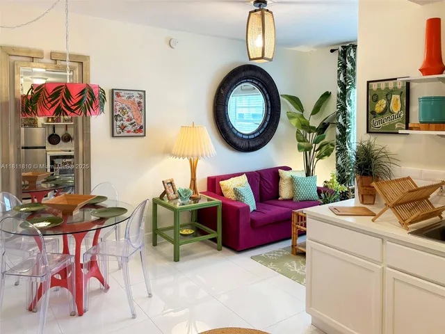 a living room with furniture a rug and a mirror