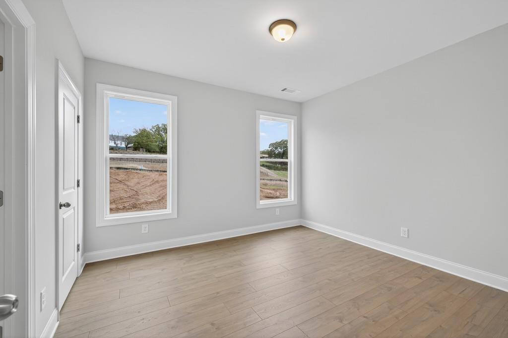 5579 Spring Street Flowery Branch, GA 30542 - Photo 19 of 65 an empty room with windows and closet