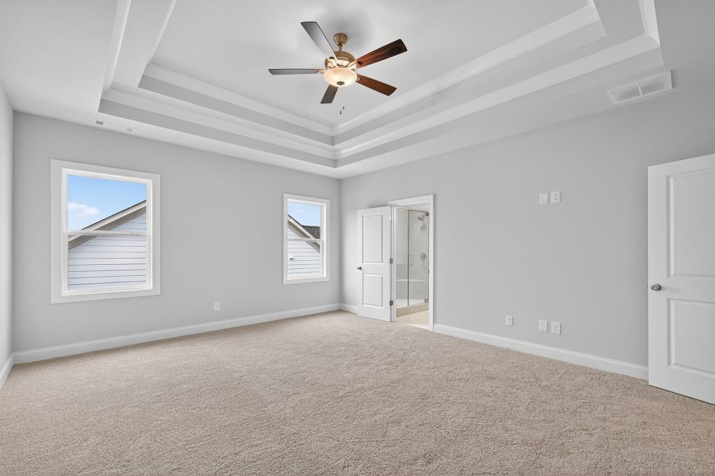 5579 Spring Street Flowery Branch, GA 30542 - Photo 25 of 65 a view of a livingroom with a ceiling fan and window