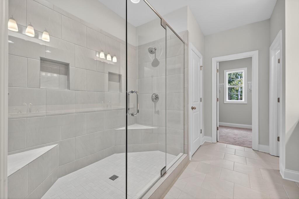 5579 Spring Street Flowery Branch, GA 30542 - Photo 29 of 65 a bathroom with a shower and a glass door