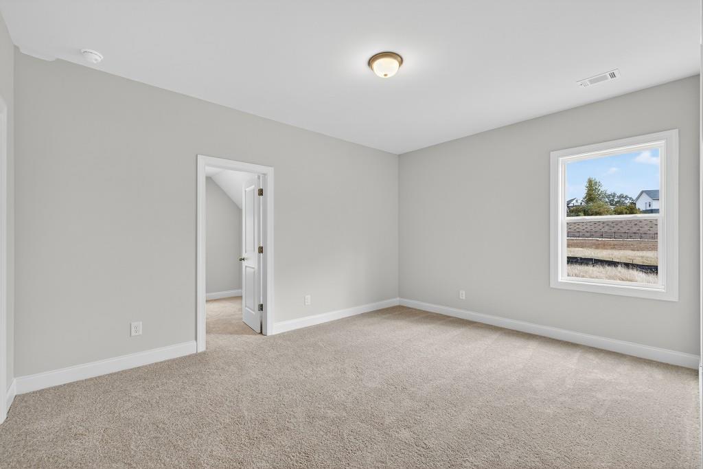 5579 Spring Street Flowery Branch, GA 30542 - Photo 32 of 65 an empty room with windows and closet