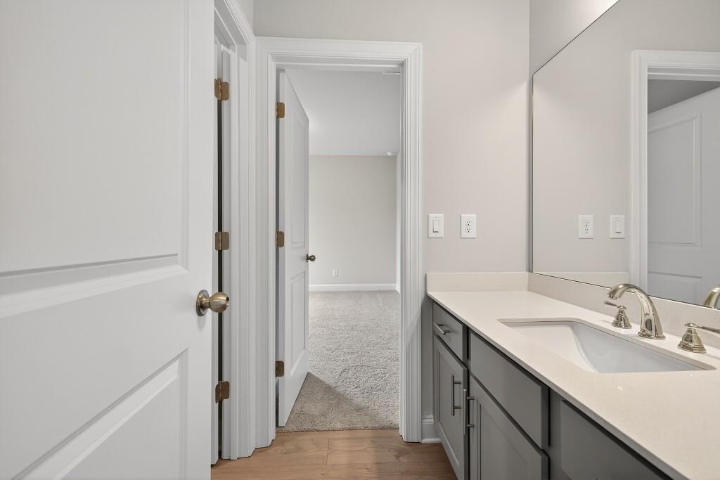 5579 Spring Street Flowery Branch, GA 30542 - Photo 35 of 65 a bathroom with a sink a mirror and a shower