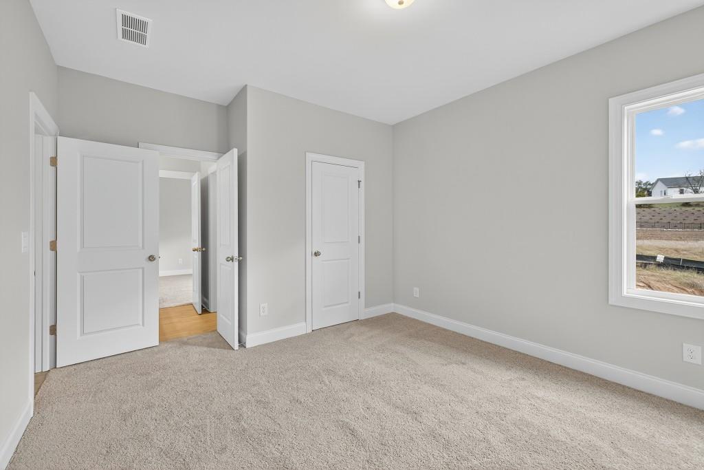 5579 Spring Street Flowery Branch, GA 30542 - Photo 38 of 65 a view of an empty room and a window