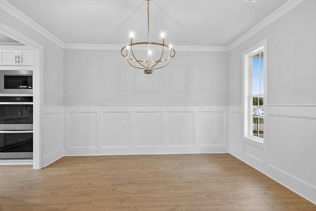 5579 Spring Street Flowery Branch, GA 30542 - Photo 5 of 65 a view of an empty room with a window