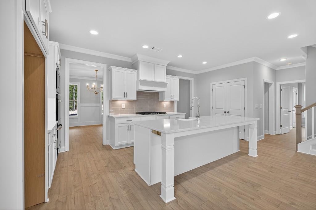 5579 Spring Street Flowery Branch, GA 30542 - Photo 9 of 65 a kitchen with white cabinets and refrigerator