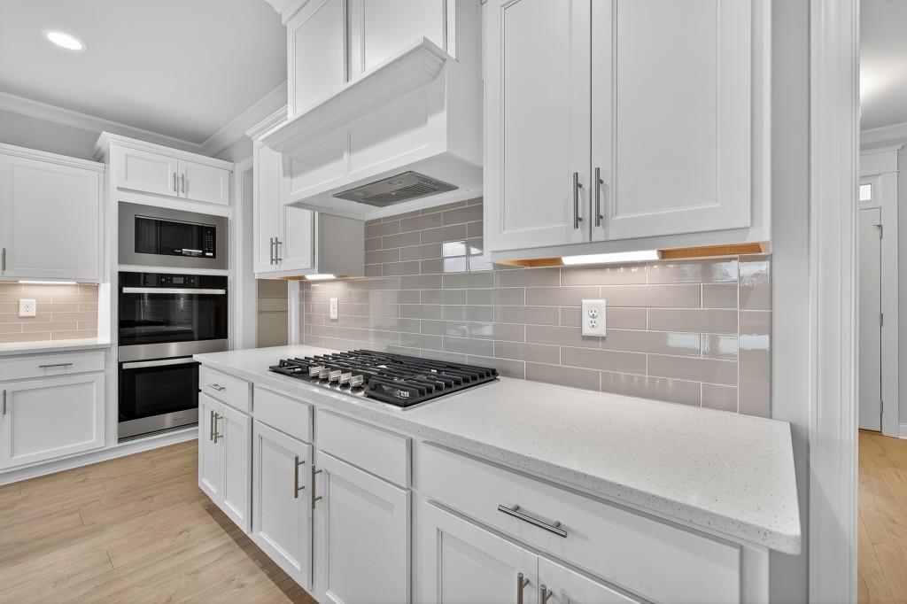 5579 Spring Street Flowery Branch, GA 30542 - Photo 10 of 65 a kitchen with white cabinets and appliances