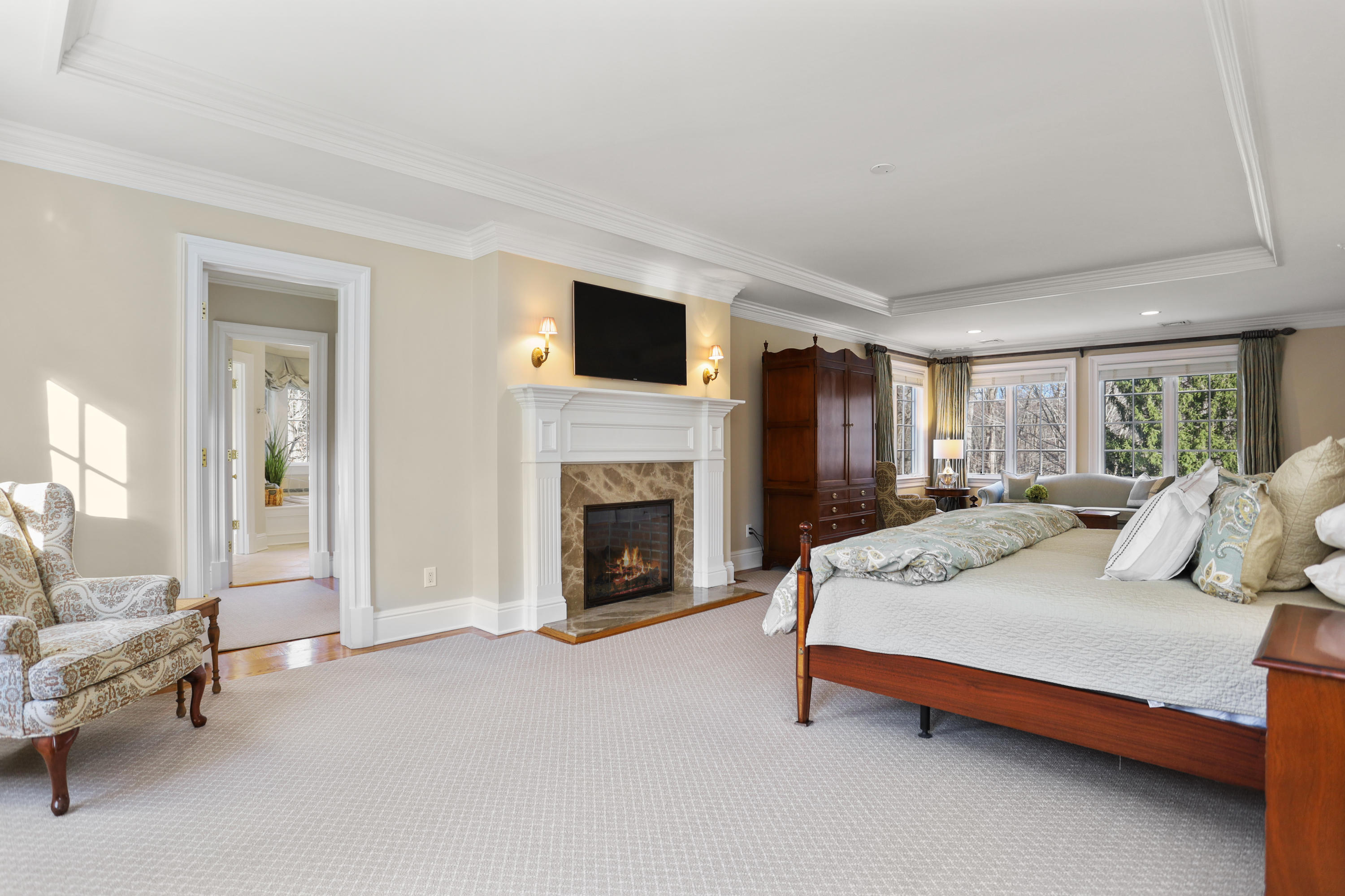 31 Ramhorne Road New Canaan, CT 06840 - Photo 22 of 56 a spacious bedroom with a bed and a fireplace