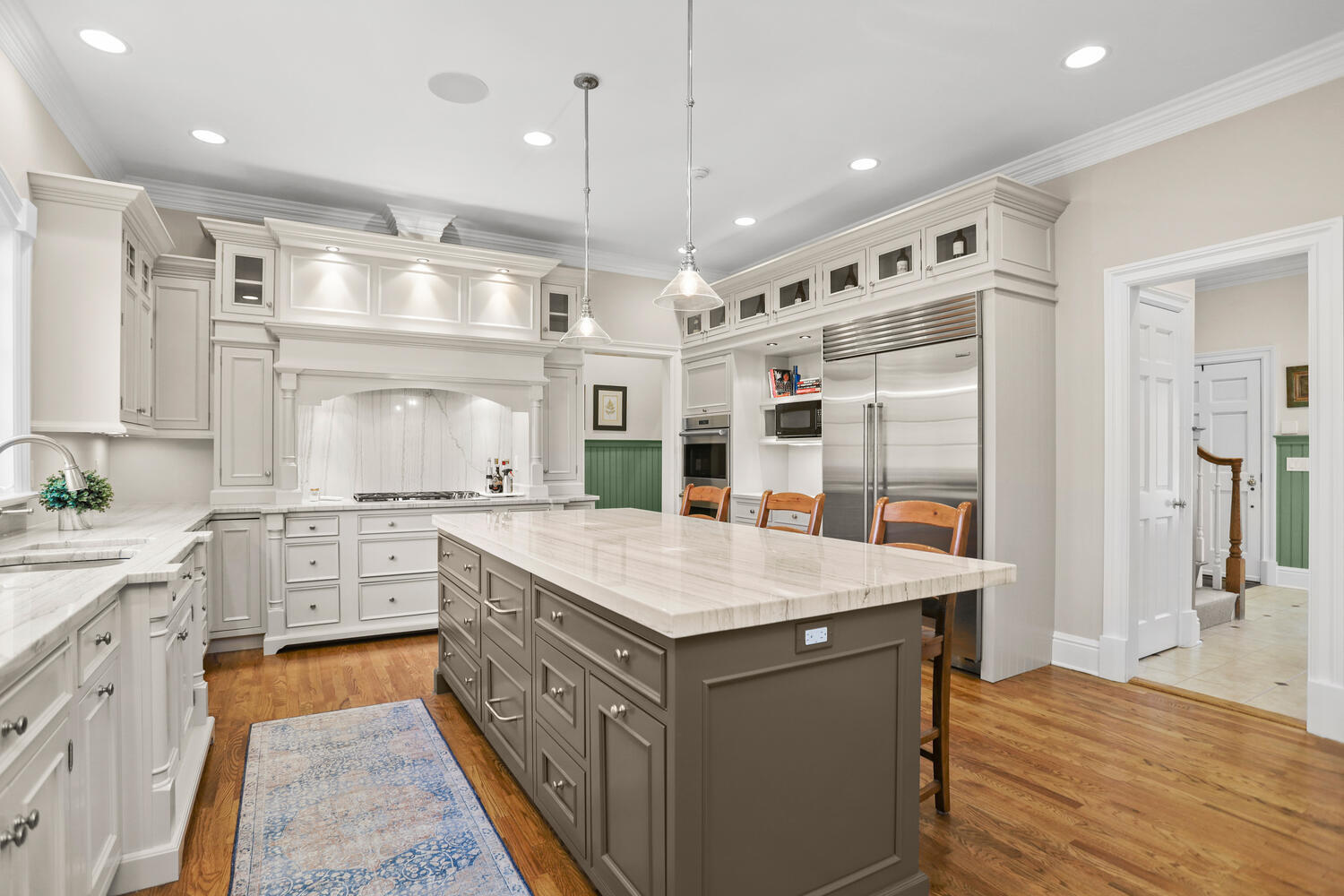 31 Ramhorne Road New Canaan, CT 06840 - Photo 6 of 56 a large kitchen with kitchen island a large counter space a sink appliances and cabinets