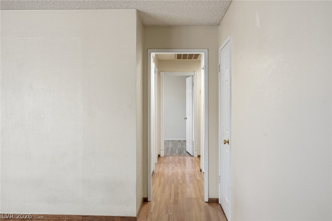 3971 Spring Leaf Drive Las Vegas, NV 89147 - Photo 29 of 48 Hardwood floors lead through a well-defined hallway to inviting rooms beyond.