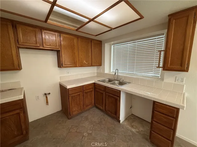 a kitchen with stainless steel appliances granite countertop wooden cabinets a sink and dishwasher