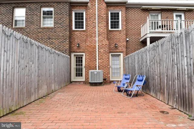a backyard of a house with table and chairs
