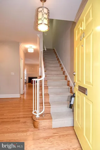 a view of entryway and hall with wooden floor