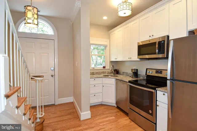 a kitchen with a stove a sink and a microwave