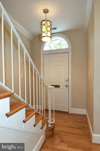 a view of a hallway with entryway wooden floor and front door