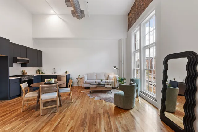 a bed room with a bed and a chair