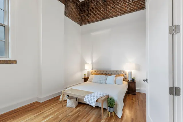 a hallway with a bed and a couch