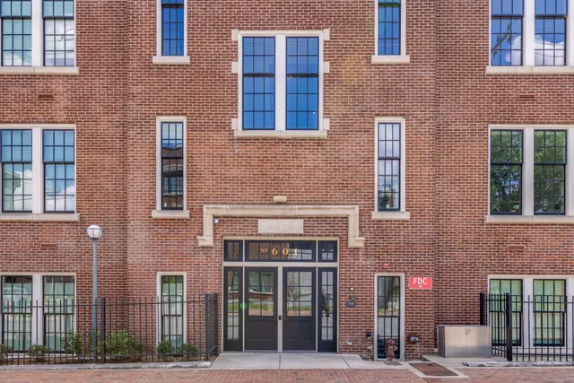 a front view of a building with a garden