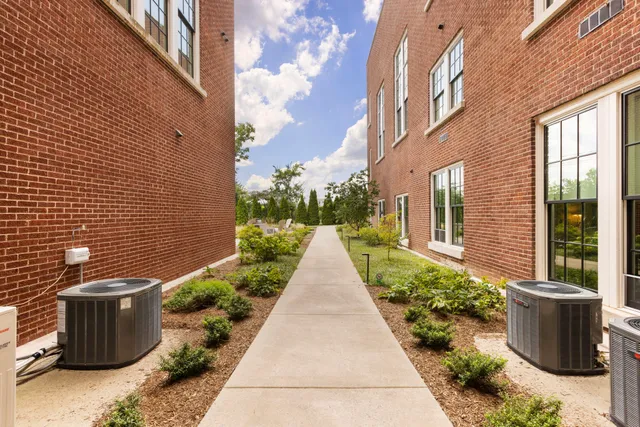 a view of a patio with a table and chairs under an umbrella