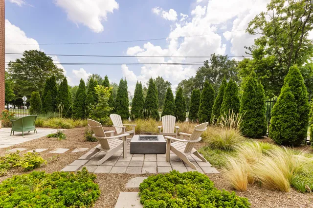 a view of a patio with chairs and potted plants