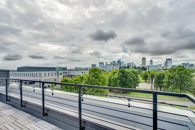 a view of a patio with a dining table and chairs with wooden floor