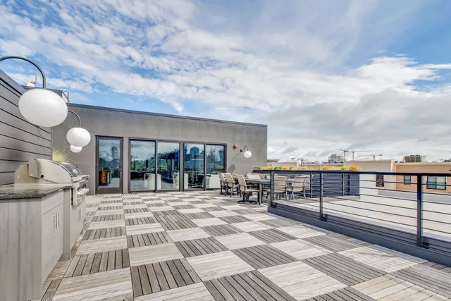 a living room with kitchen island furniture and a flat screen tv
