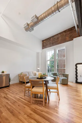 a view of a workspace with furniture and wooden floor
