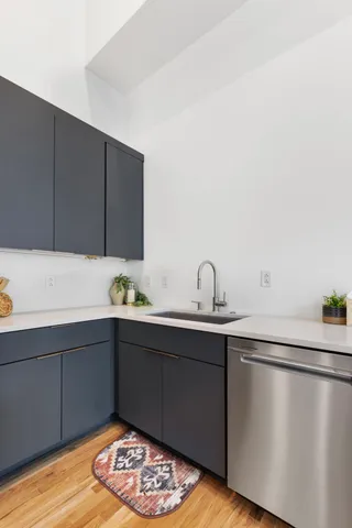 a living room with couch and a wooden floor