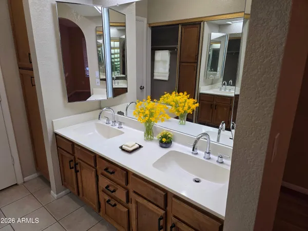 a bathroom with a double vanity sink and a mirror