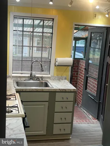 a room with a sink and a mirror