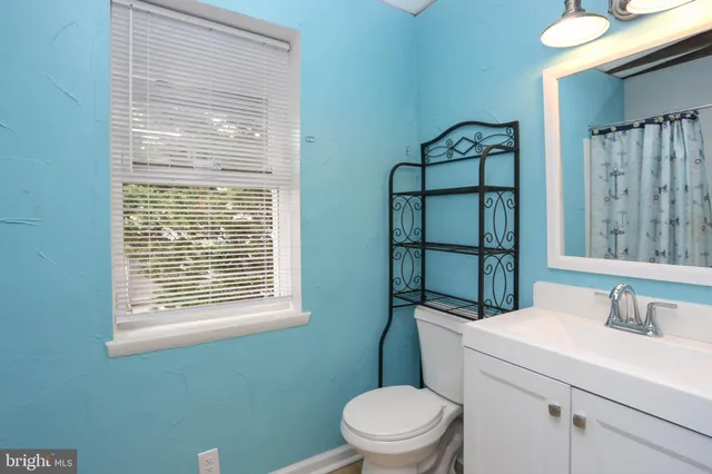 a bathroom with a toilet sink and mirror