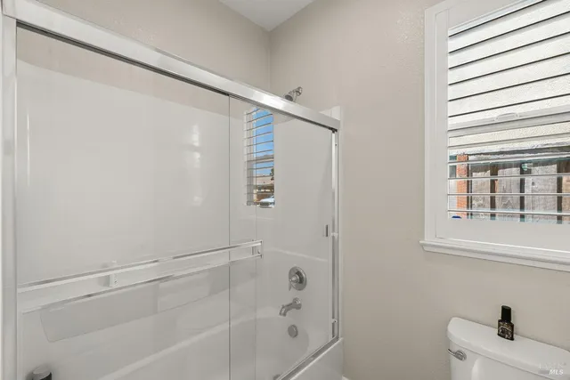 a view of a dining room with furniture a chandelier and wooden floor