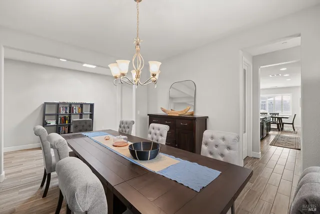 a kitchen with stainless steel appliances granite countertop wooden floors and stove top oven