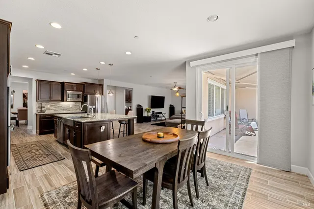 a kitchen with stainless steel appliances granite countertop a sink refrigerator and cabinets