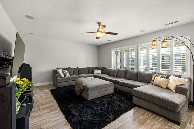 a bedroom with a bed a window and a chandelier
