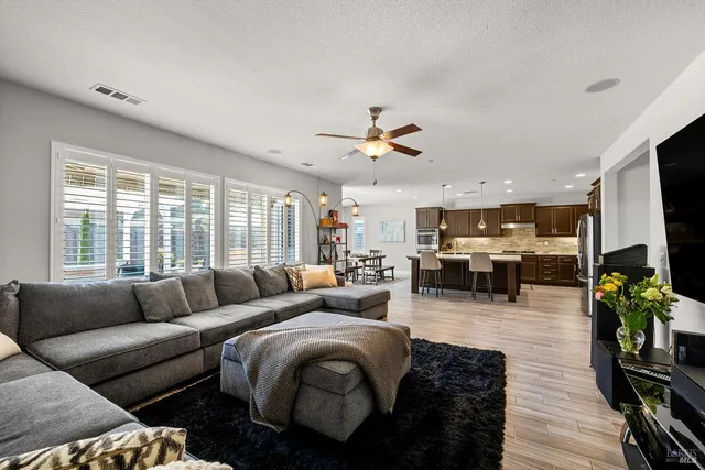 a bedroom with a bed and a lamp on the dresser
