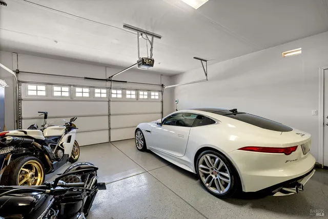 an aerial view of residential houses with outdoor space and parking