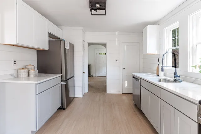a kitchen with a sink and a refrigerator
