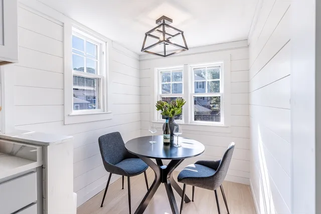 a view of a dining room with furniture and window