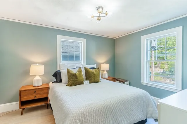 a bedroom with a bed and a lamp