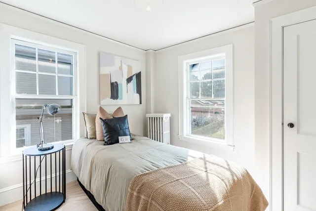 a bedroom with a large bed and a window