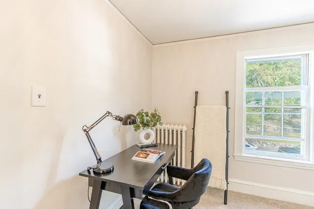 a view of a room with a table and chairs