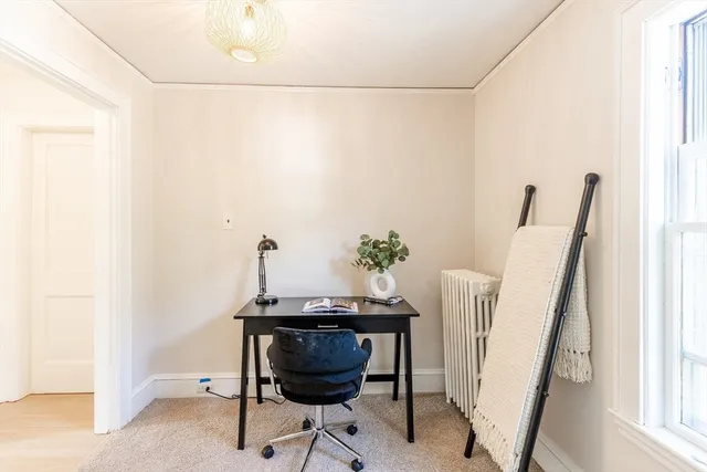 a view of a room with furniture and wooden floor