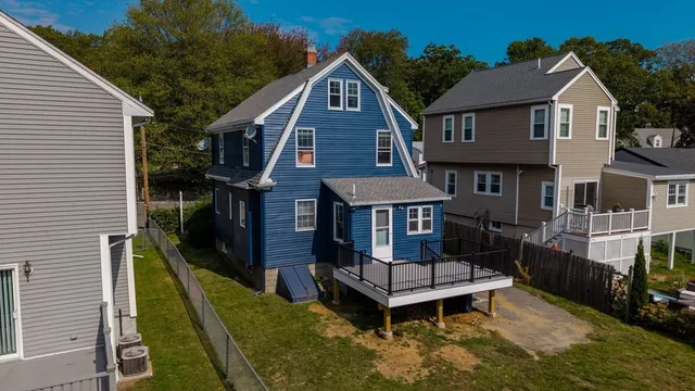 a aerial view of a house with a yard and potted plants