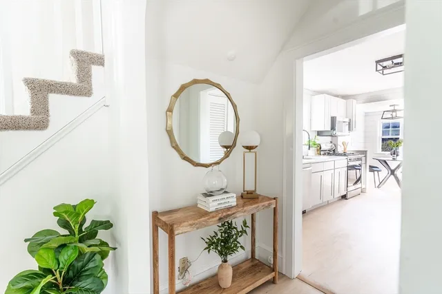 a living room with furniture a chandelier and a dining table