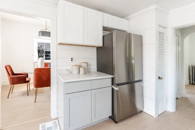 a kitchen with a refrigerator and cabinets